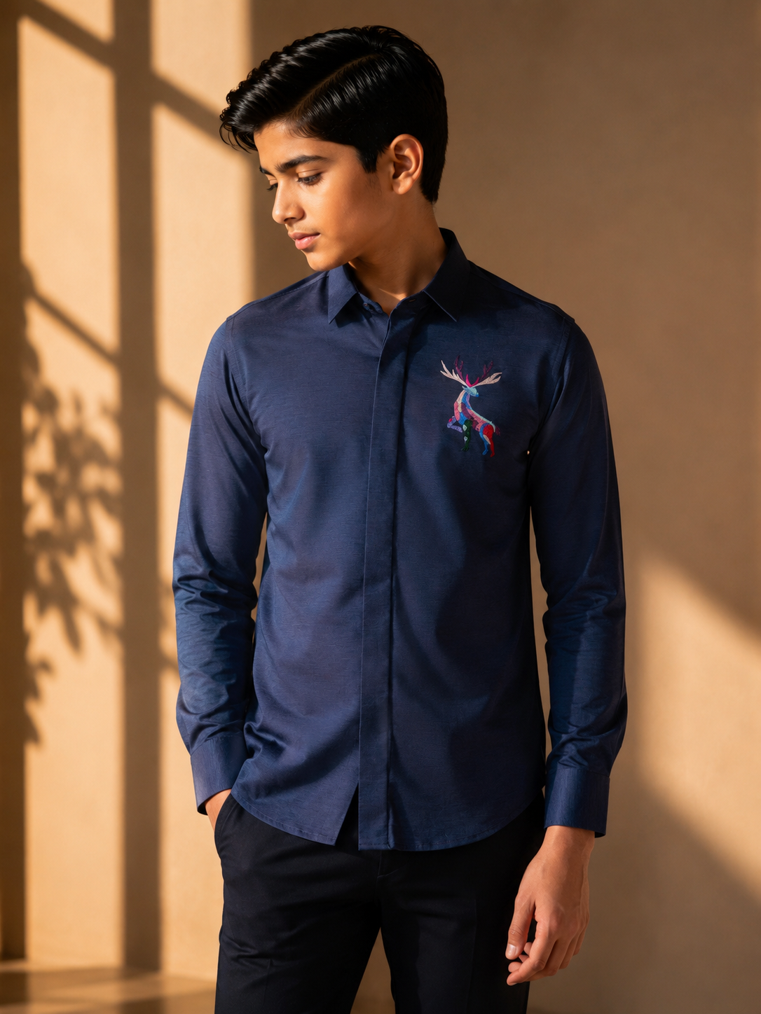 Navy blue knit shirt with embroidered multi-coloured Reindeer motif