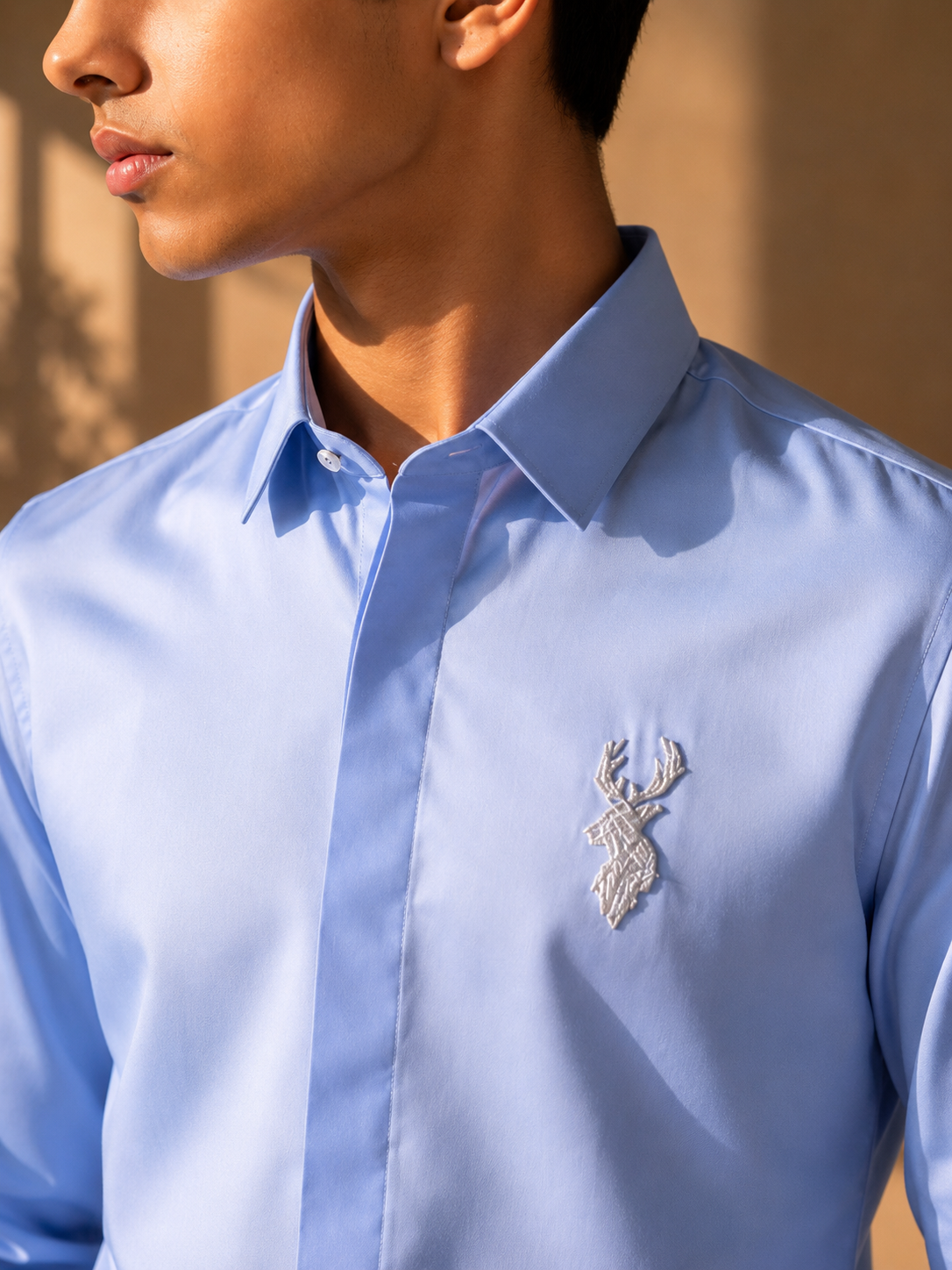 Sky blue shirt with metallic hand-embroidered Reindeer motif