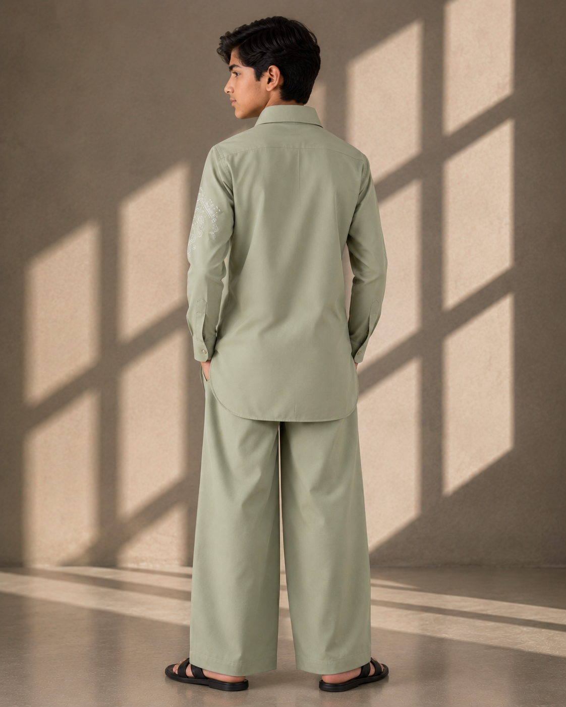 Mint green short crepe kurta with thread embroidery detailing on the sleeve, paired with a matching plazzo