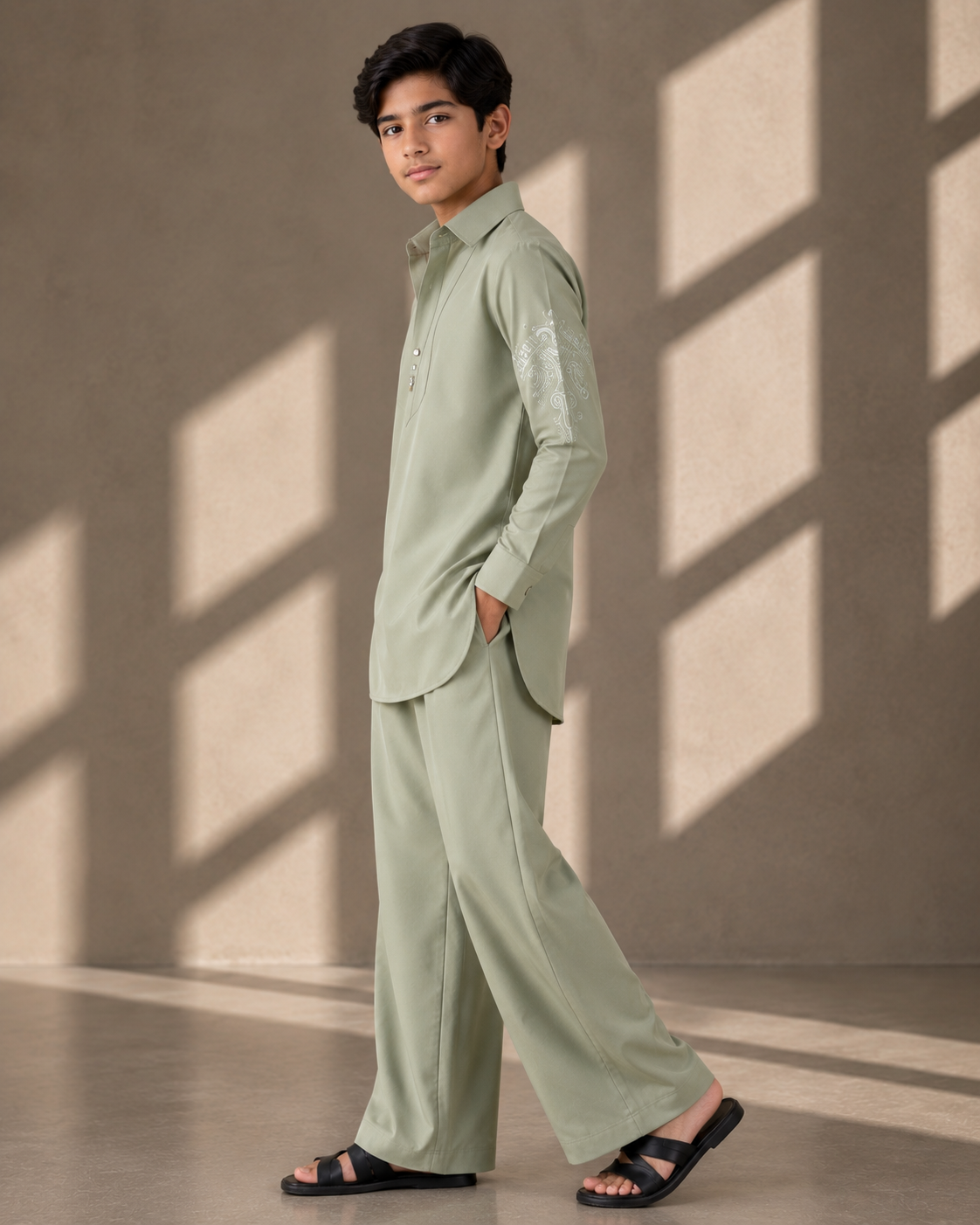 Mint green short crepe kurta with thread embroidery detailing on the sleeve, paired with a matching plazzo