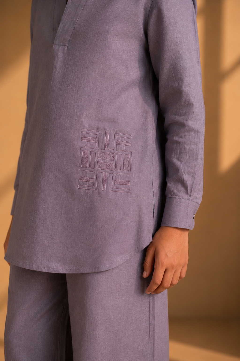 Mauve short linen kurta with thread embroidery detailing on the waist, paired with a matching plazzo