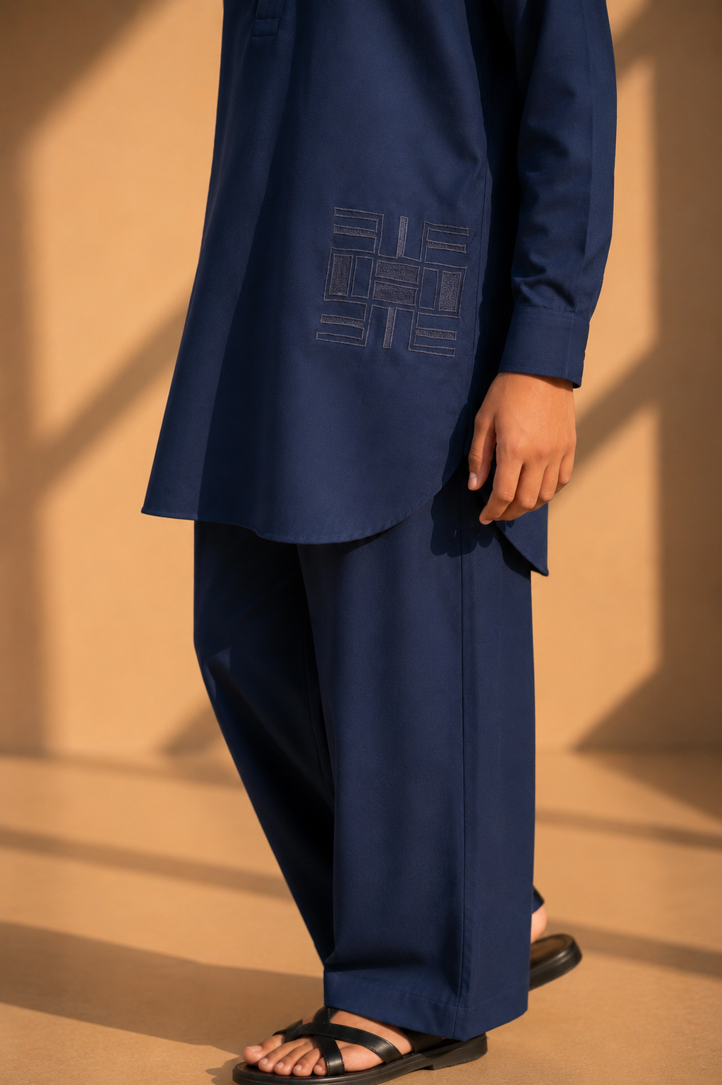 Navy blue short crepe kurta with thread embroidery detailing on the waist, paired with a matching plazzo