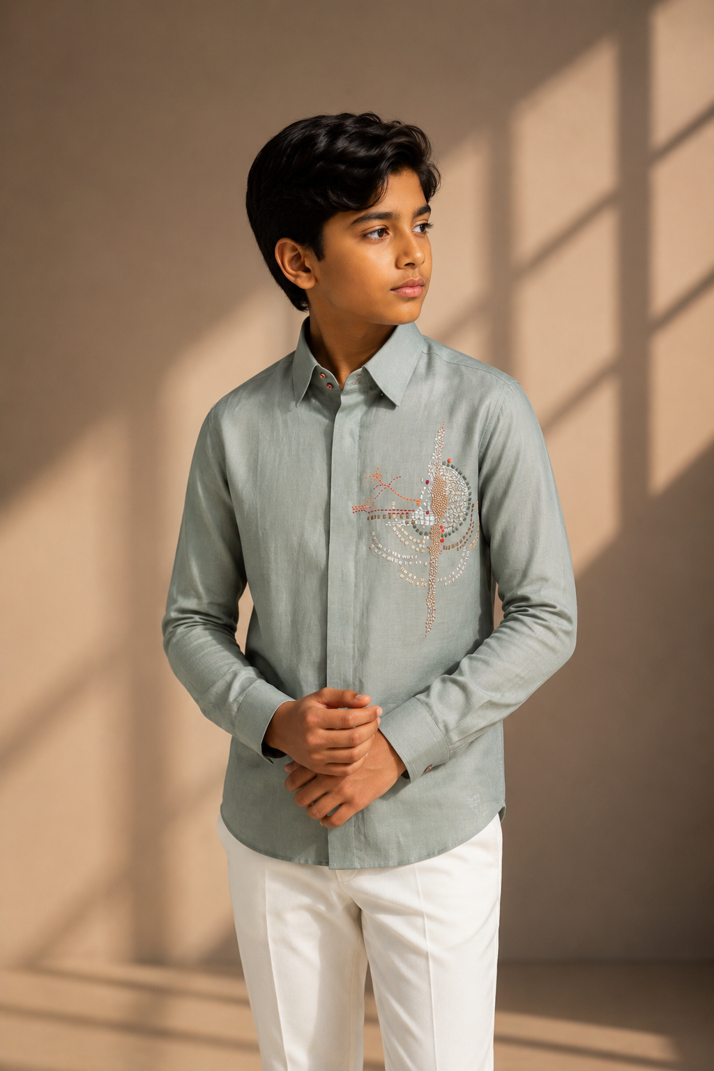 Sage green linen shirt with multi-coloured hand-embroidered motif