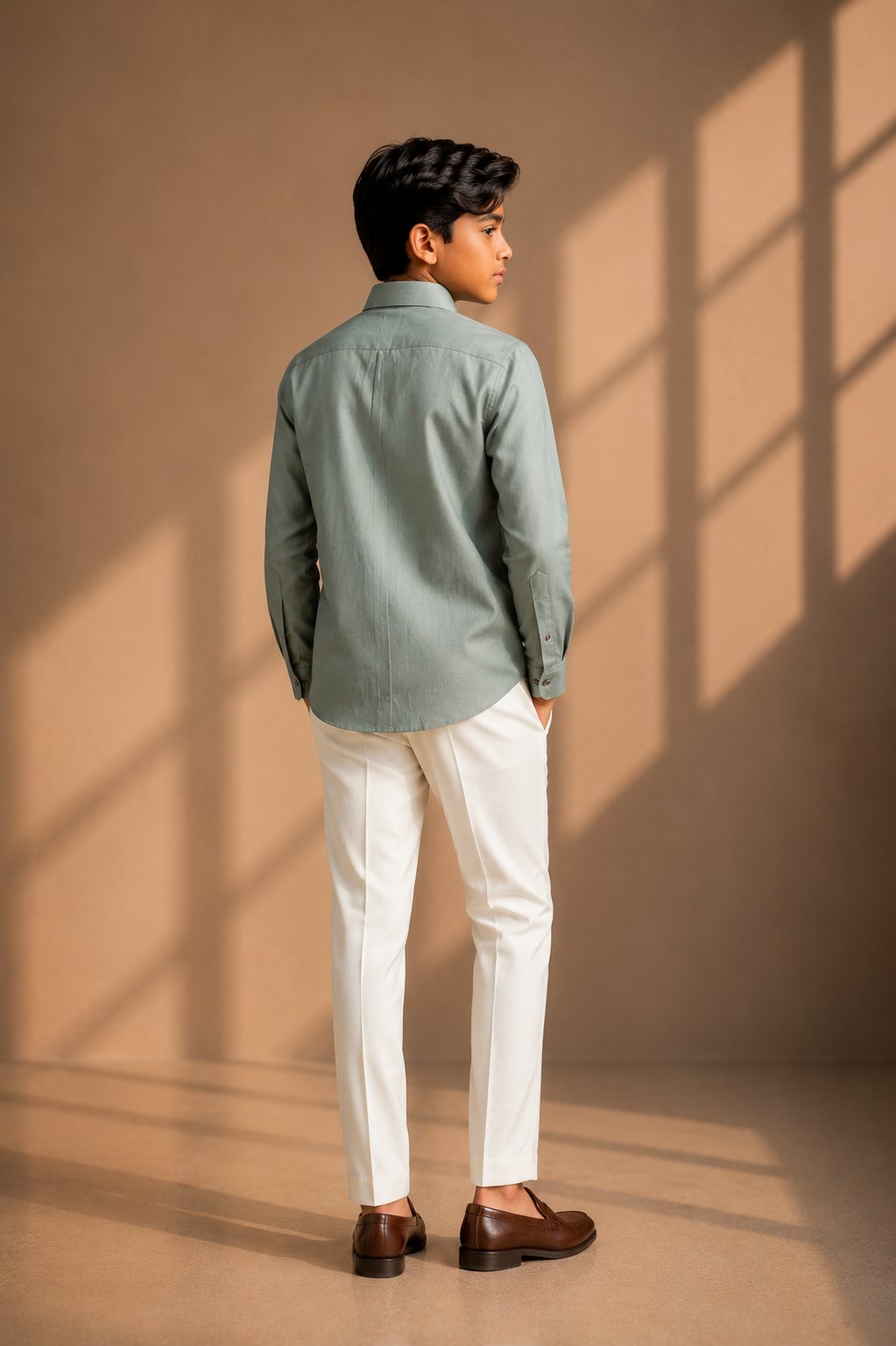 Sage green linen shirt with multi-coloured hand-embroidered motif