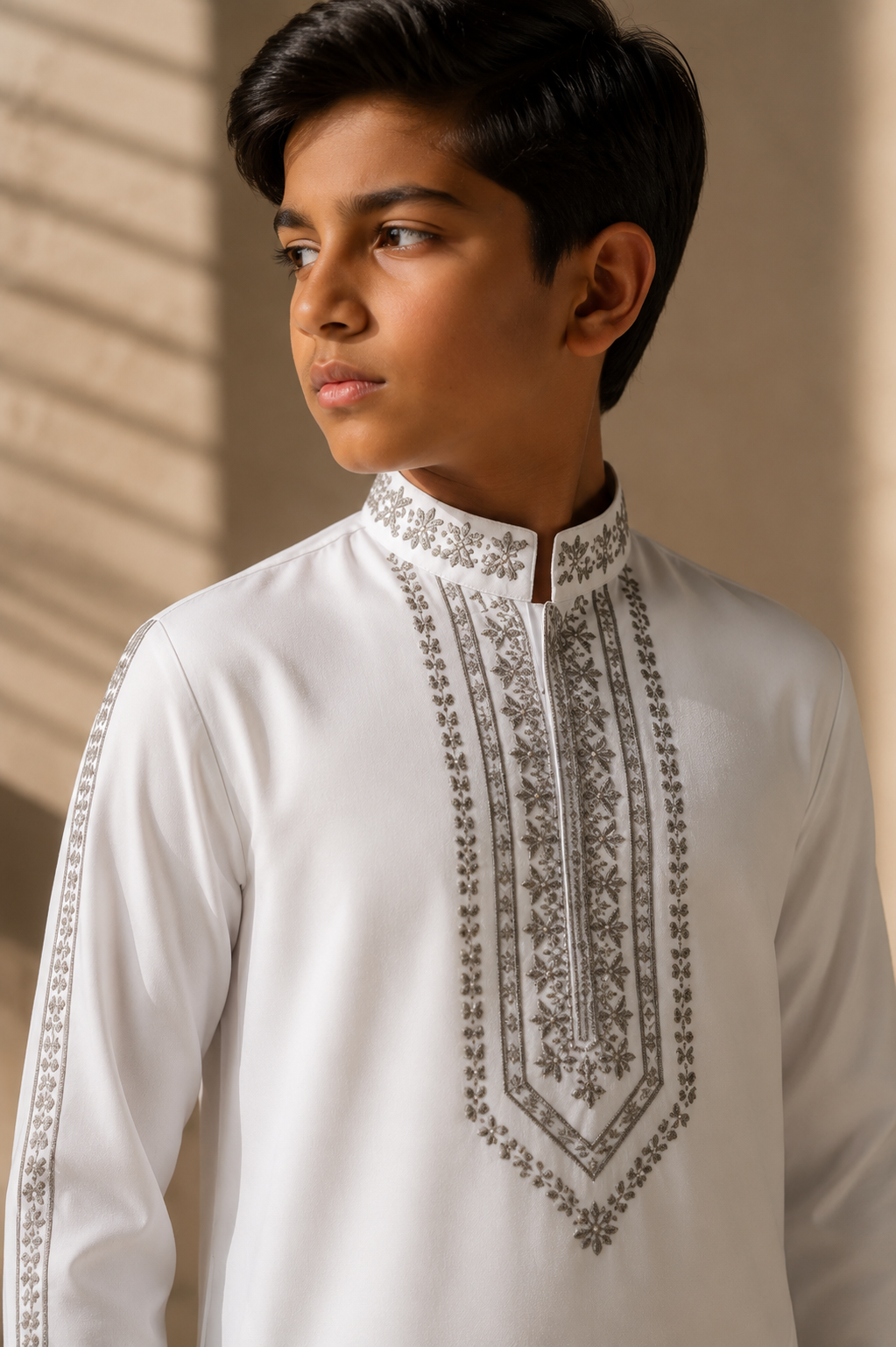 Featuring white knit kurta embelished with metal hand embroidery highlighting placket and sleeves paired with aligarhi pants