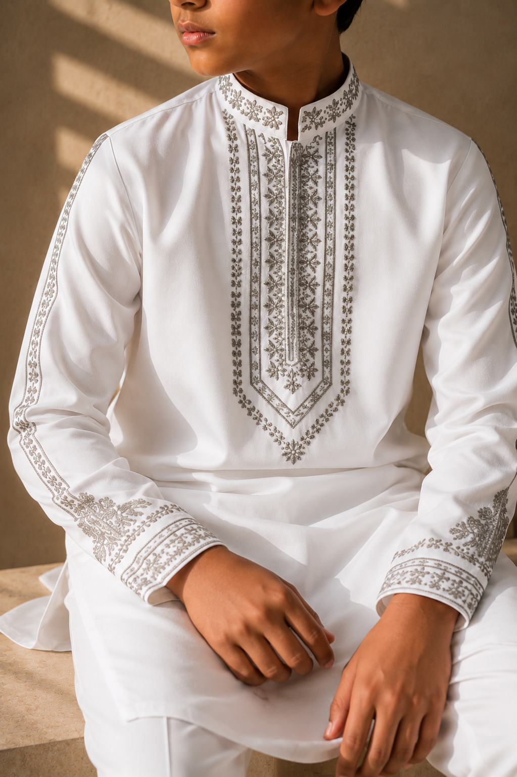 Featuring white knit kurta embelished with metal hand embroidery highlighting placket and sleeves paired with aligarhi pants