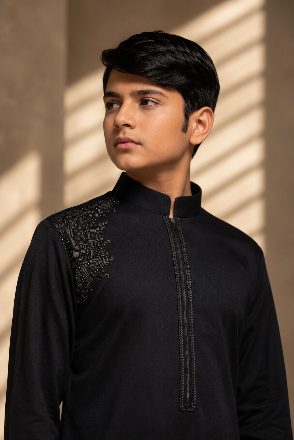 Featuring black knit kurta embellished with antique metal components on one shoulder and zipper detailing paired with aligarhi pants