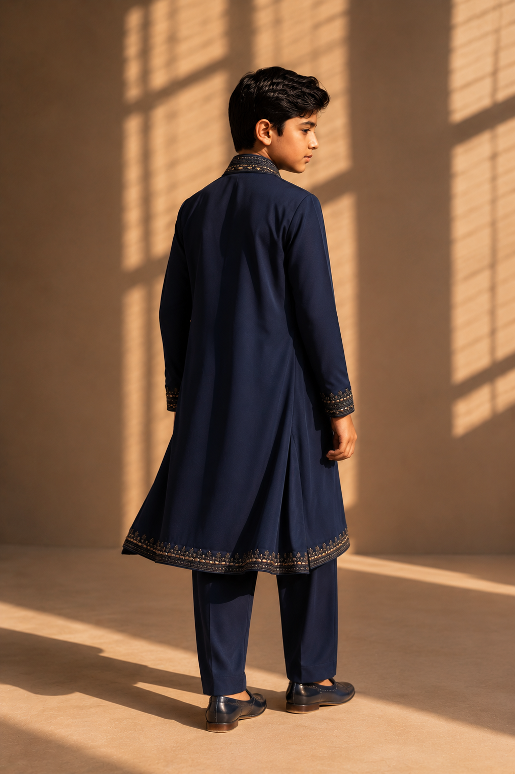 Featuring navy knit kurta embelished with antique grey metal components paired up with embroidered stole and aligarhi pants
