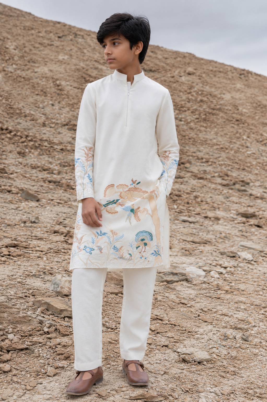 Featuring ivory silk kurta with bottom pannel and sleeves embroidery inpsired by asian art form paired with aligarhi pants. Perfrect attire to be worn in day wedding functions