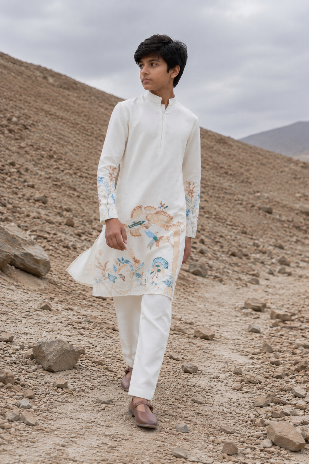 Featuring ivory silk kurta with bottom pannel and sleeves embroidery inpsired by asian art form paired with aligarhi pants. Perfrect attire to be worn in day wedding functions