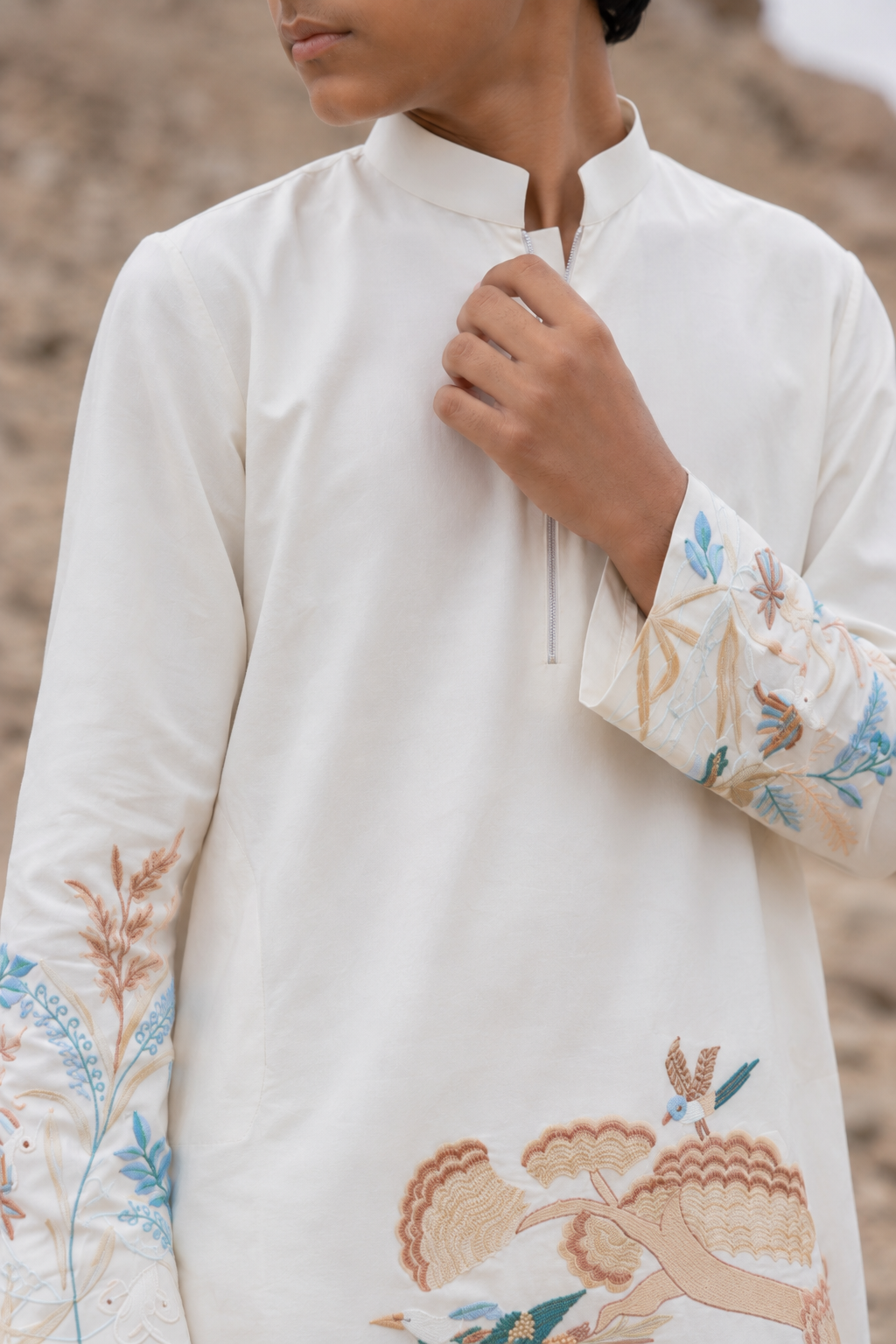 Featuring ivory silk kurta with bottom pannel and sleeves embroidery inpsired by asian art form paired with aligarhi pants. Perfrect attire to be worn in day wedding functions