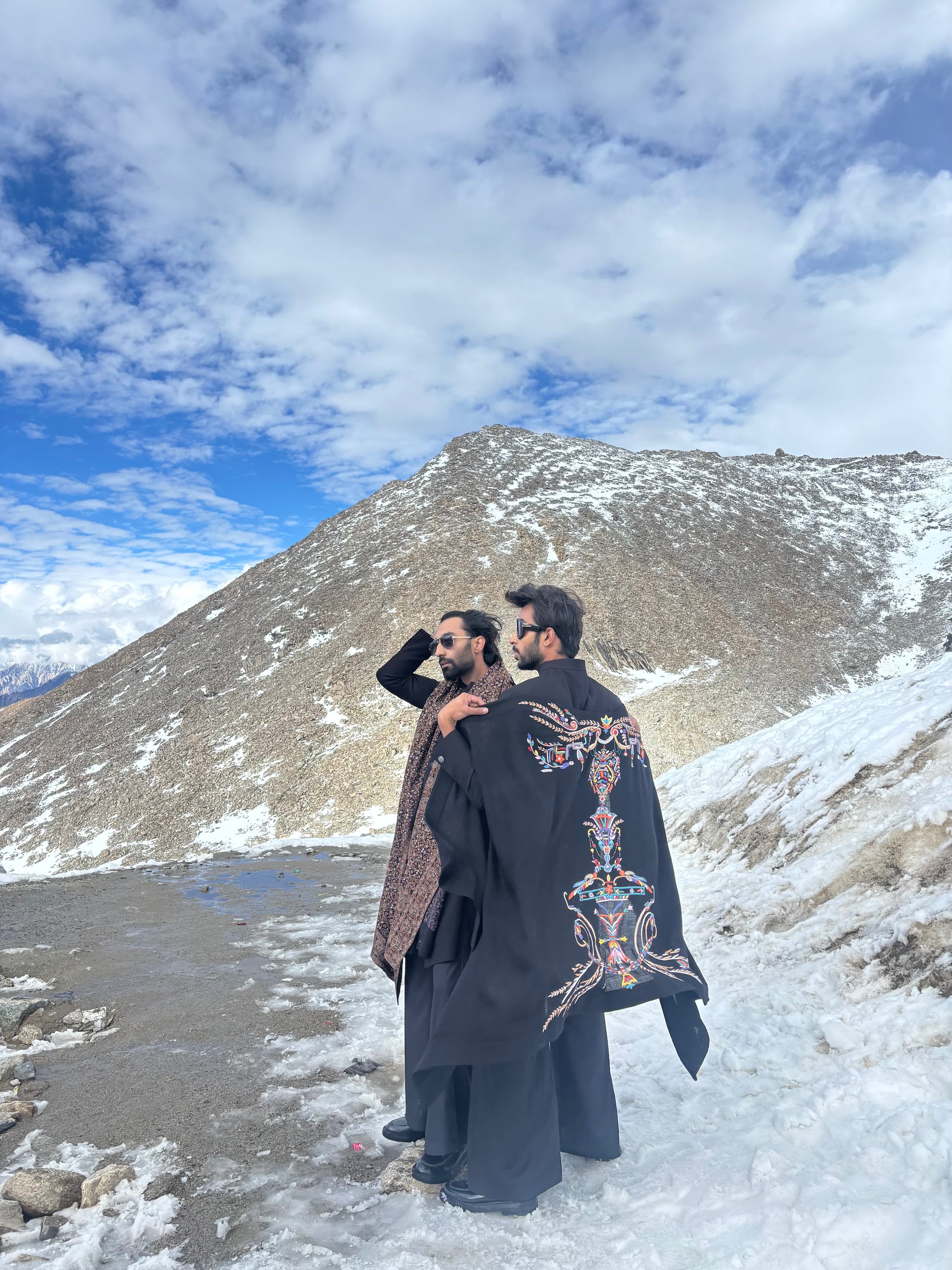 Black front zippered, long textured knit indowestern paired with a black plazo along with an embroidered pashmina stole.