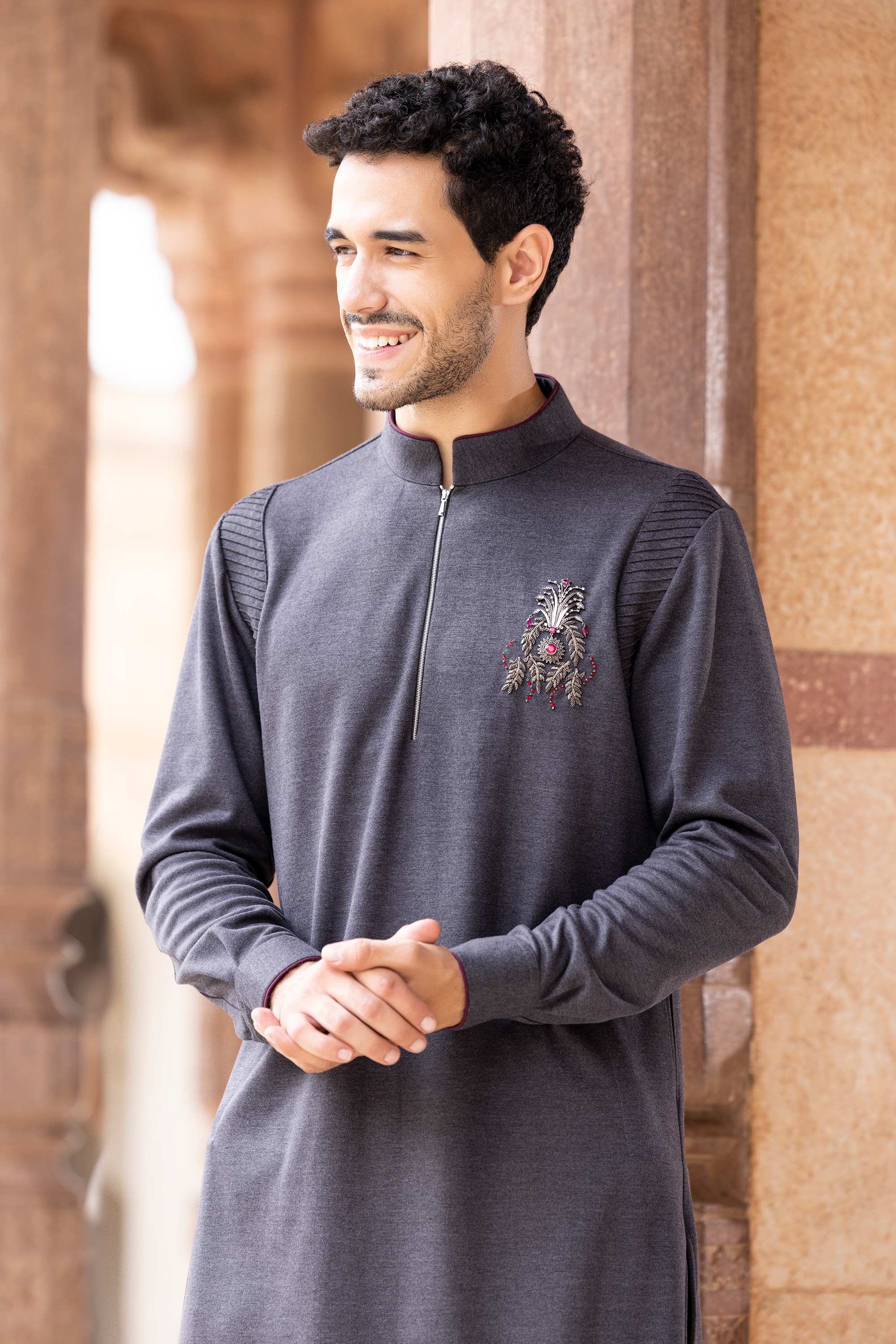 Knit kurta embellished with brooch and hand embroidery motif.