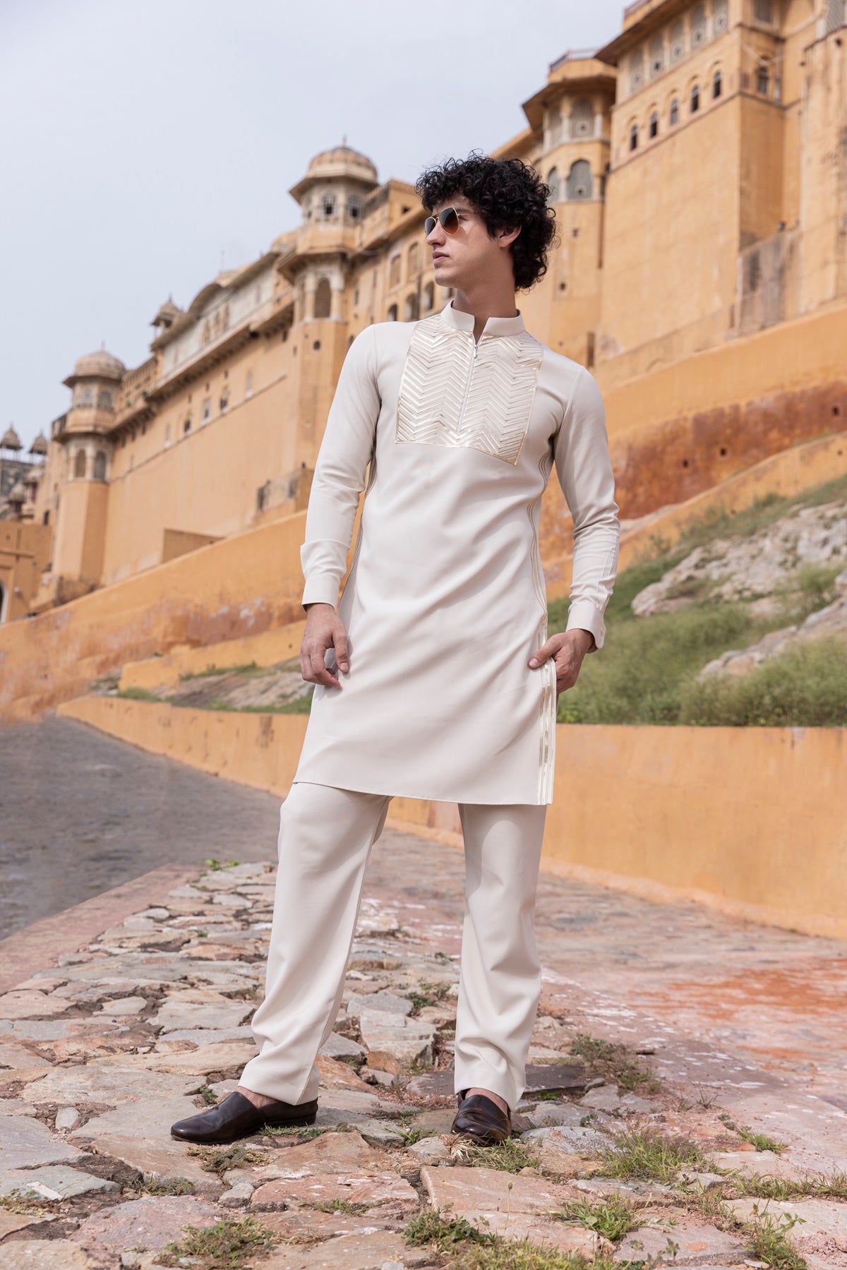 Tape work kurta paired with aligadhi.