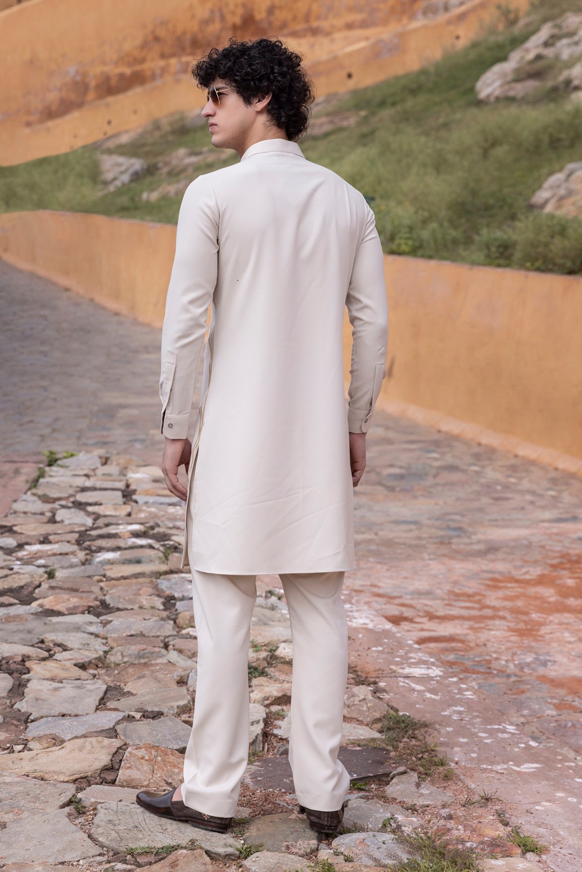 Tape work kurta paired with aligadhi.