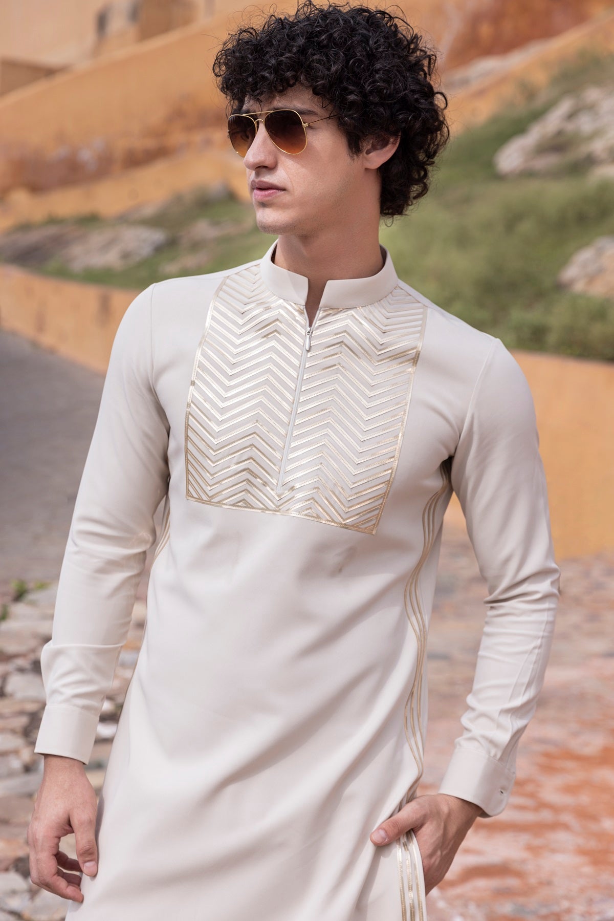 Tape work kurta paired with aligadhi.