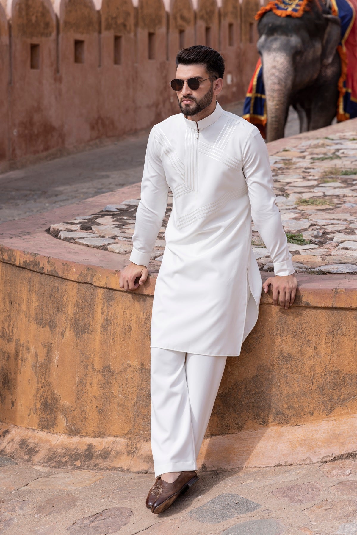 Tape work kurta paired with aligadhi.