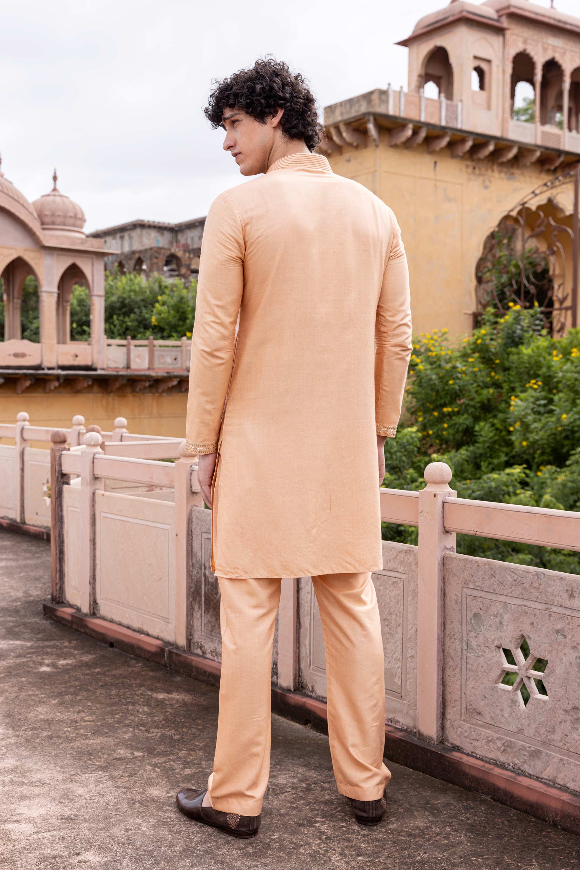 Metal work kurta paired with aligadhi.