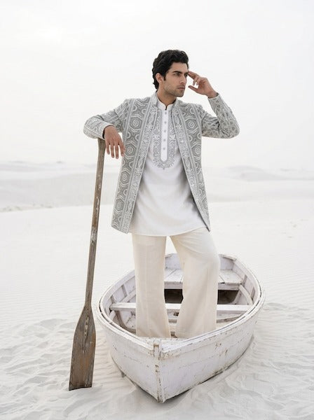 Sage green textured rayon Indo-Western jacket with ivory dori embroidery, paired with an embroidered ivory knit kurta and matching pants.