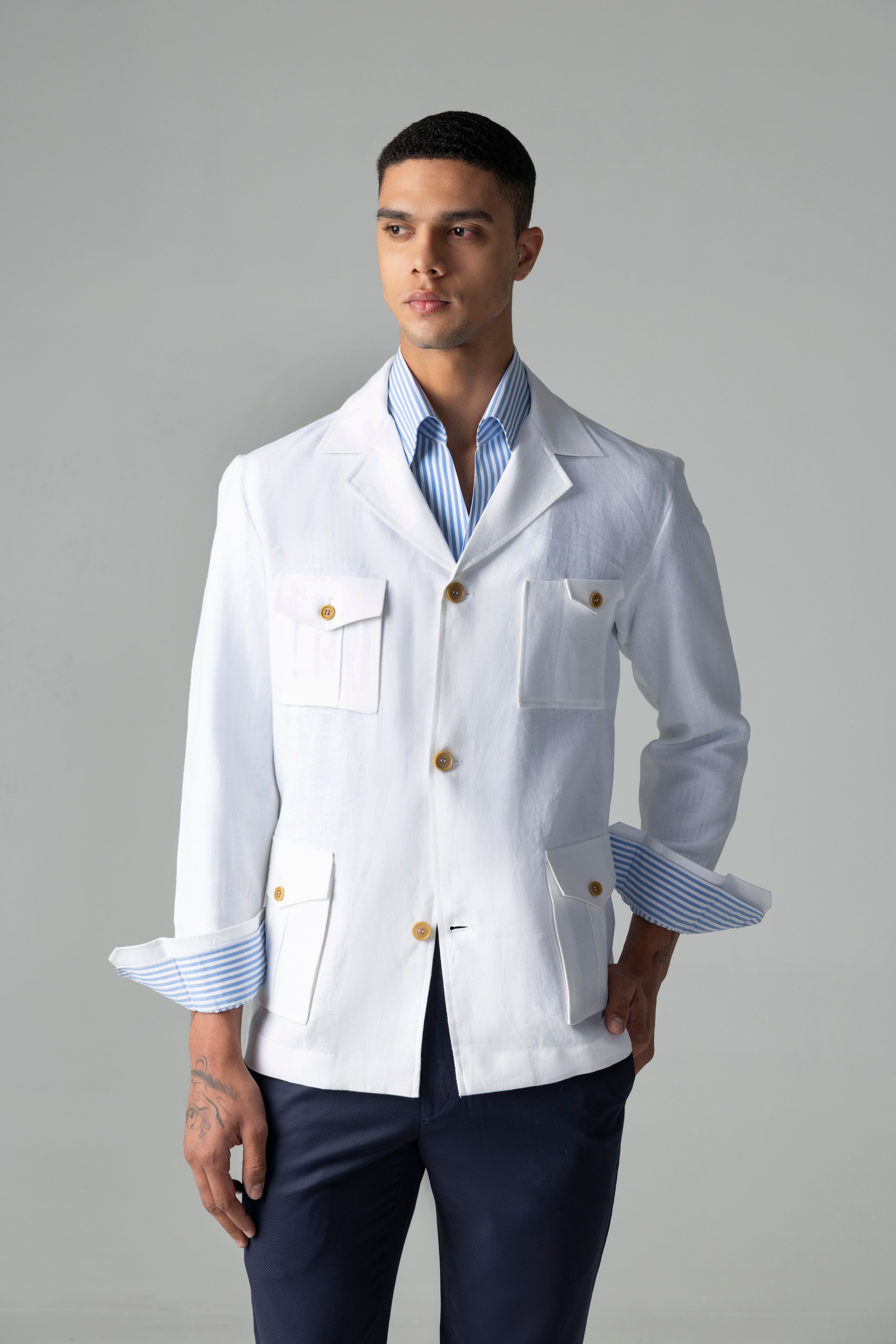 Whiite linen shacket with four patch pockets, button down collar and contrast button detailing