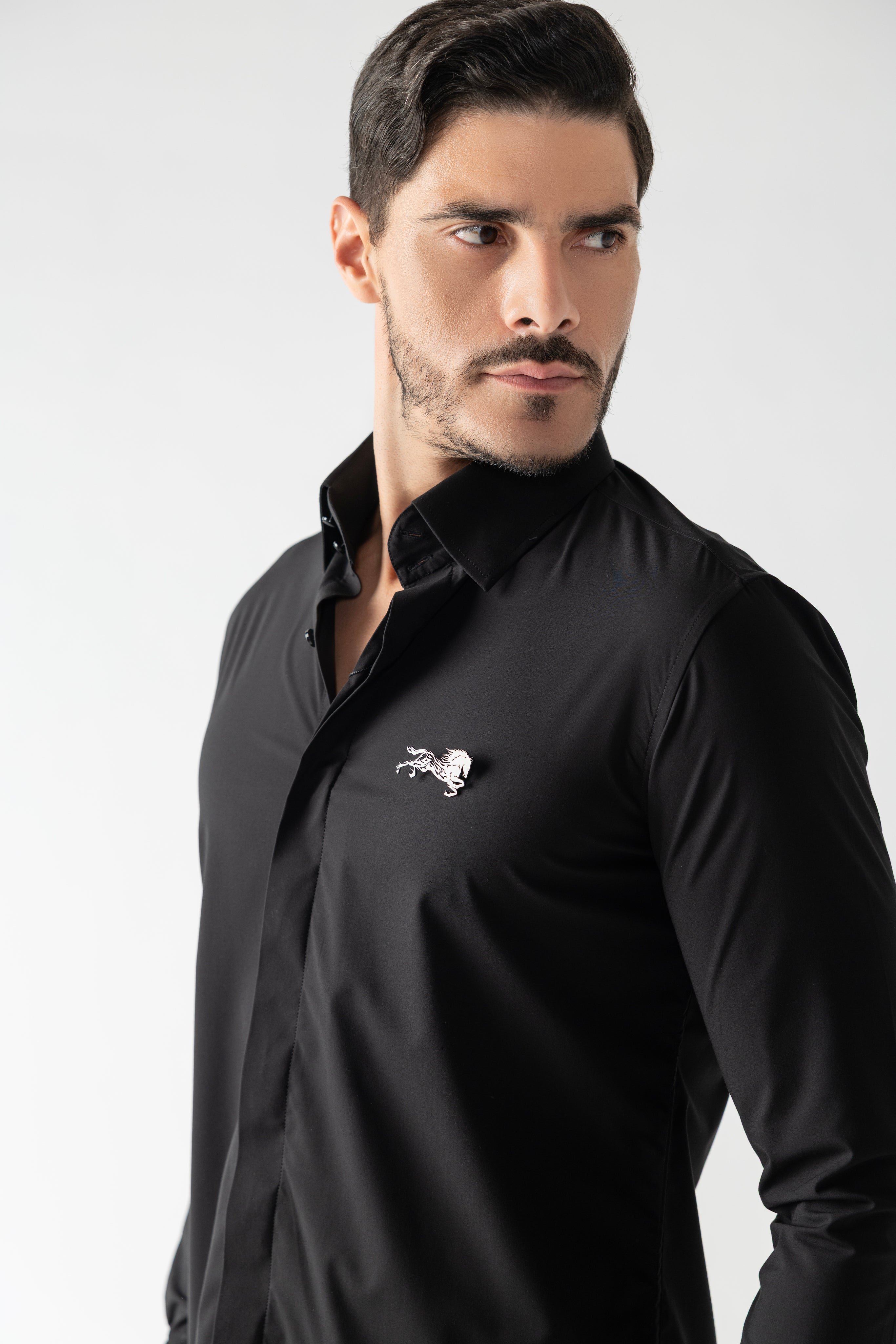 Black shirt with hidden button placket & a horse brooch.