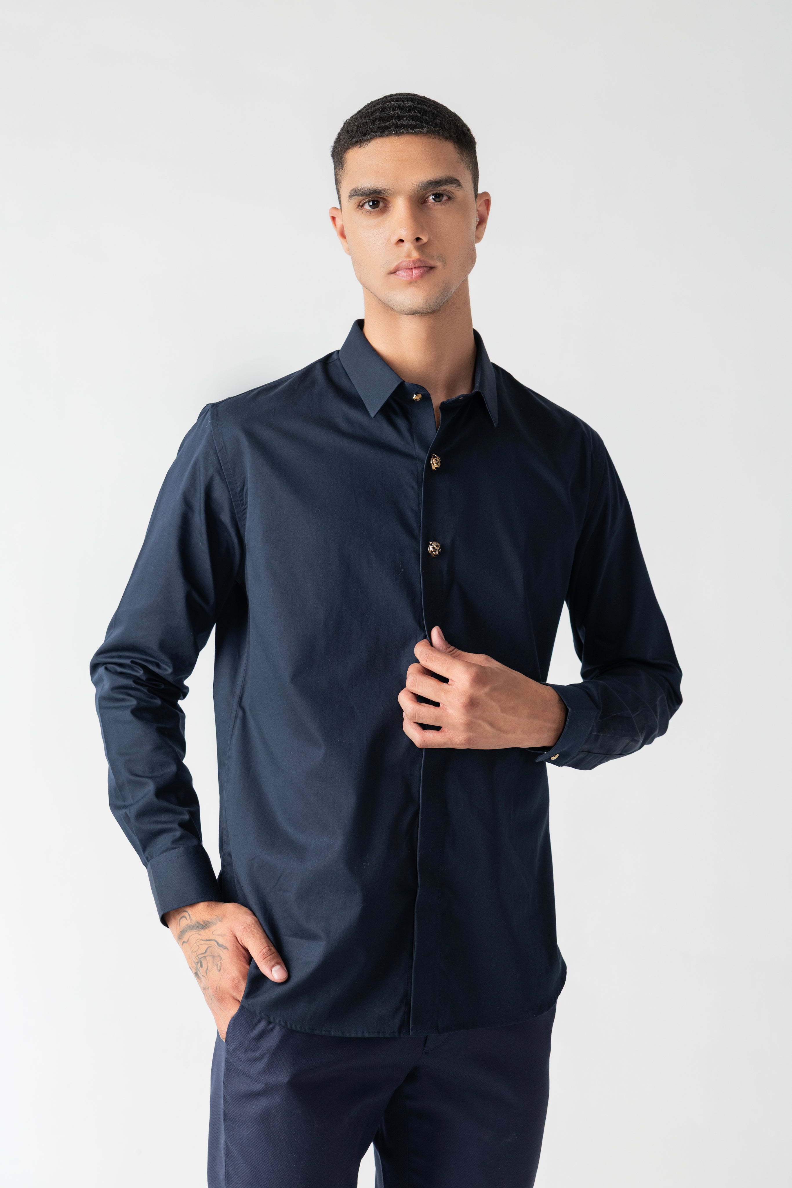 Navy blue hidden button placket shirt with leopard button detailing.