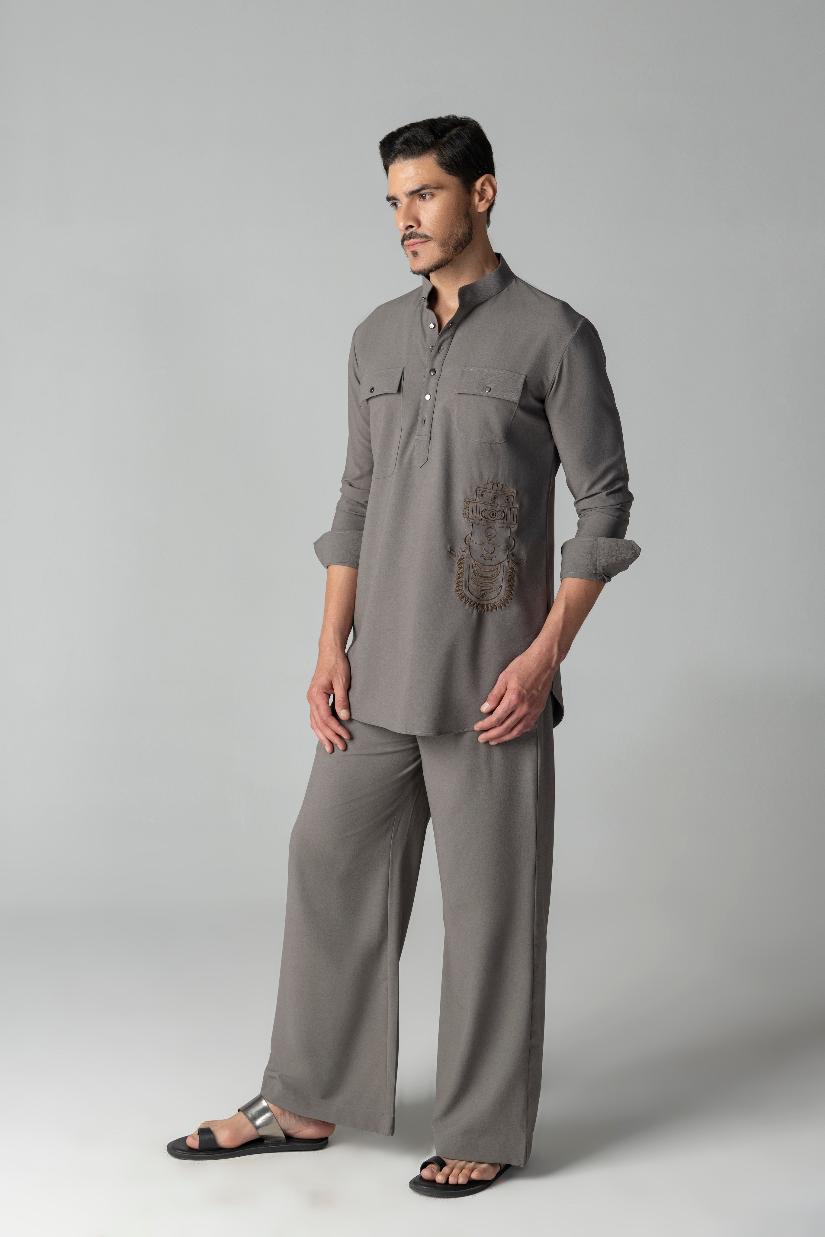 Mouse coloured short crepe kurta with thread embroidery on the waist & patch pocket detailing, paired with a matching plazzo
