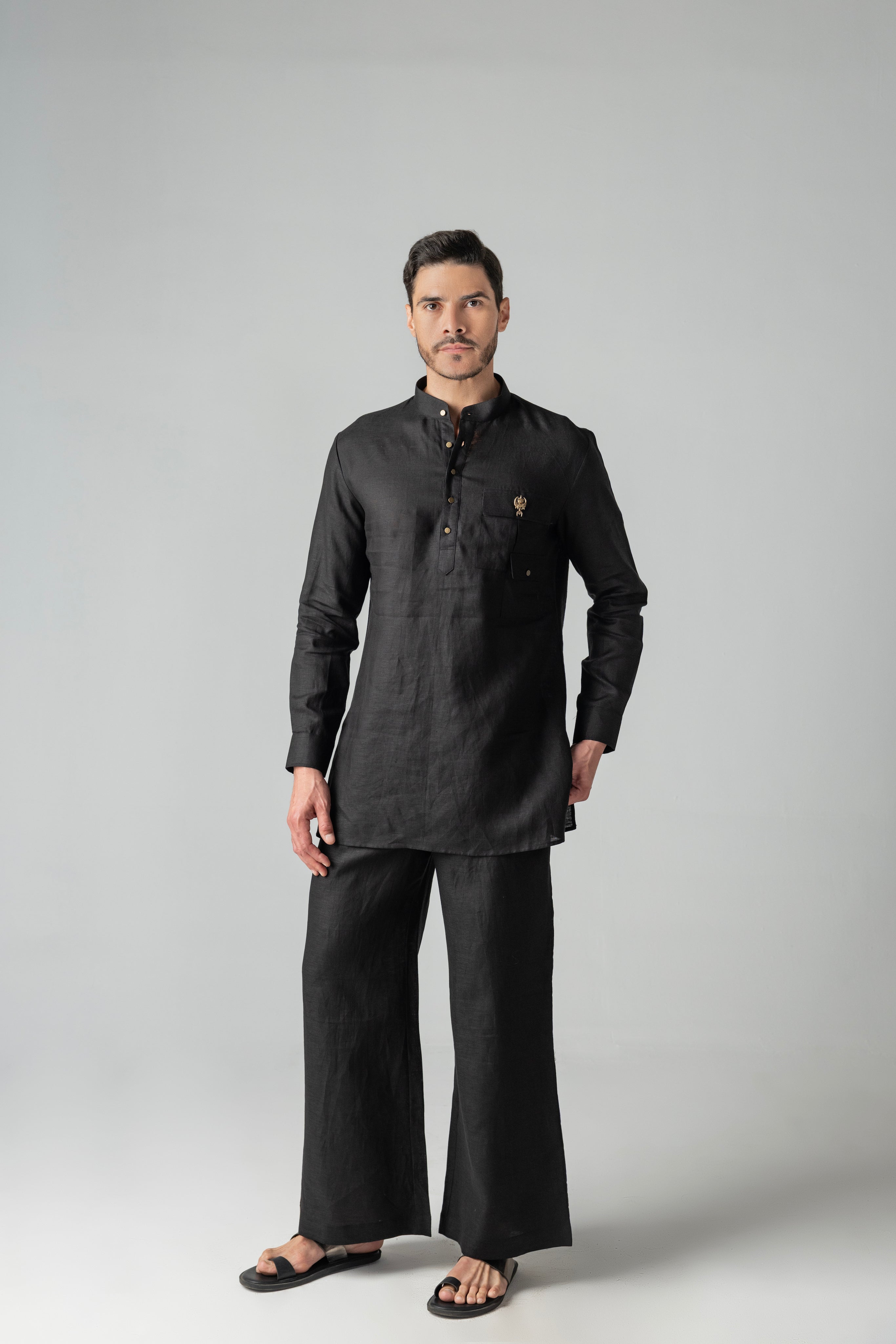 Black short linen kurta with patch pocket & brooch detailing, paired with a matching plazzo