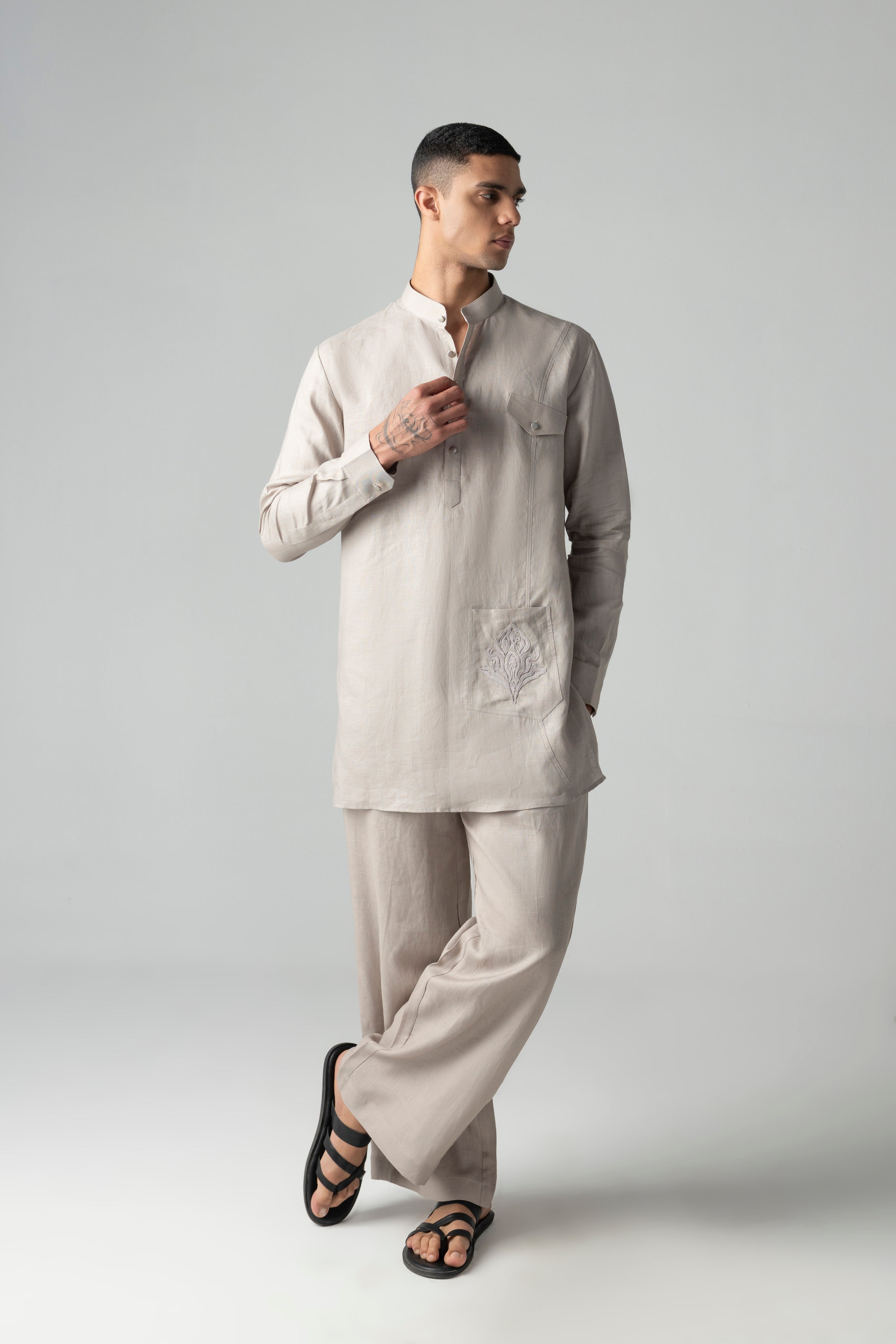 Beige short linen kurta with embroidered patch pocket detailing, paired with a matching plazzo