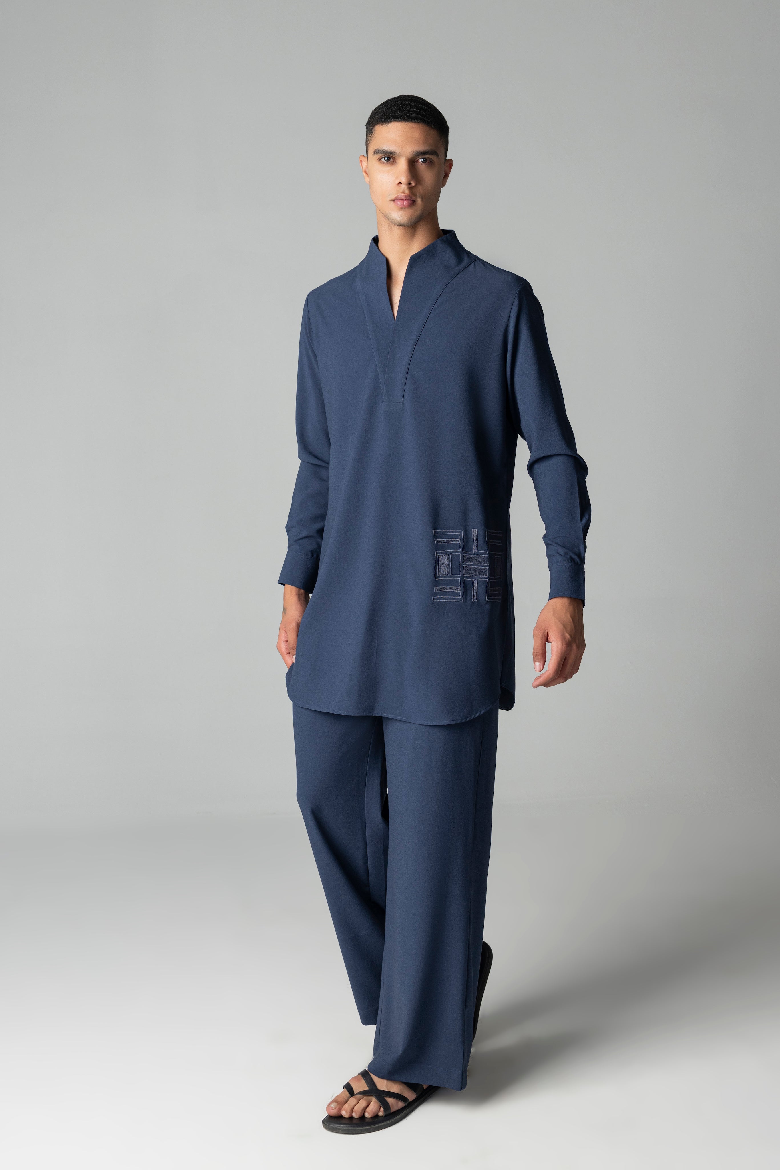 Navy blue short crepe kurta with thread embroidery detailing on the waist, paired with a matching plazzo