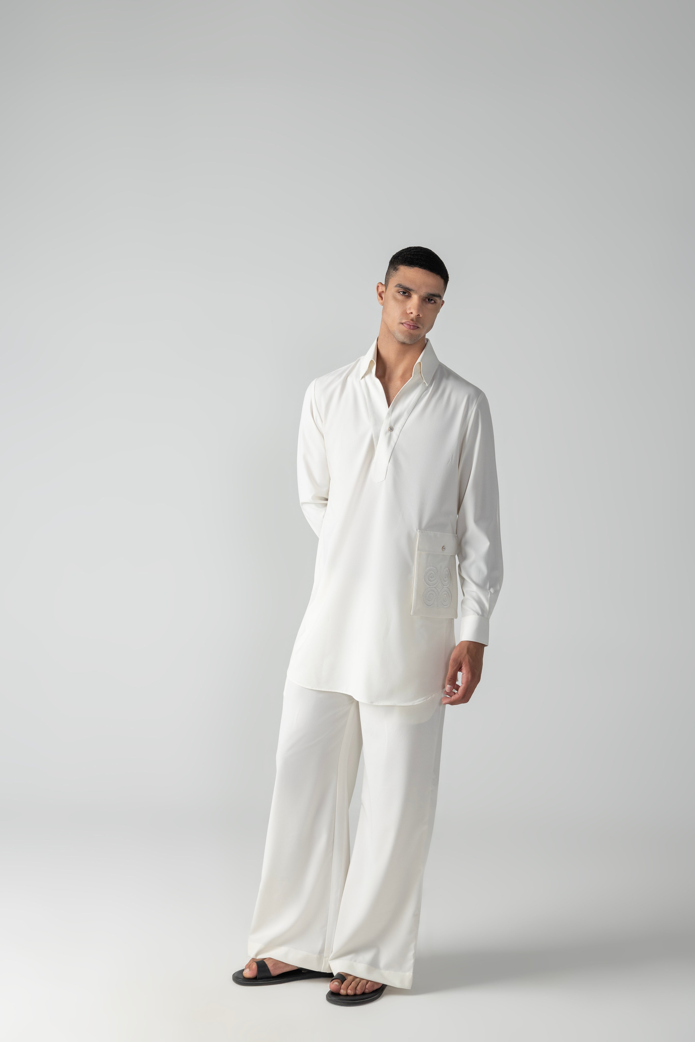 Ivory short crepe kurta with embroidered patch pocket detailing, paired with a matching plazzo