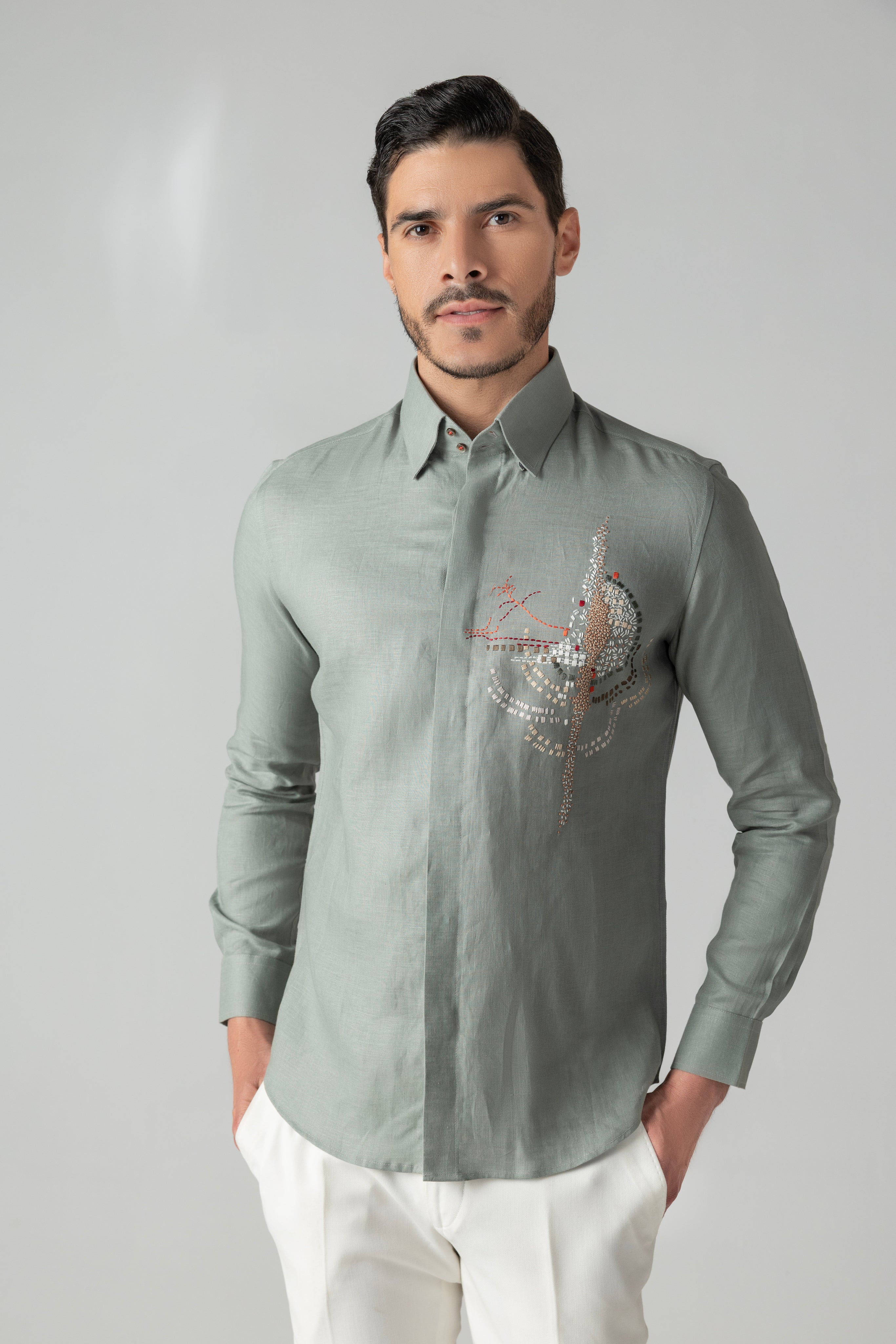 Sage green linen shirt with multi-coloured hand-embroidered motif