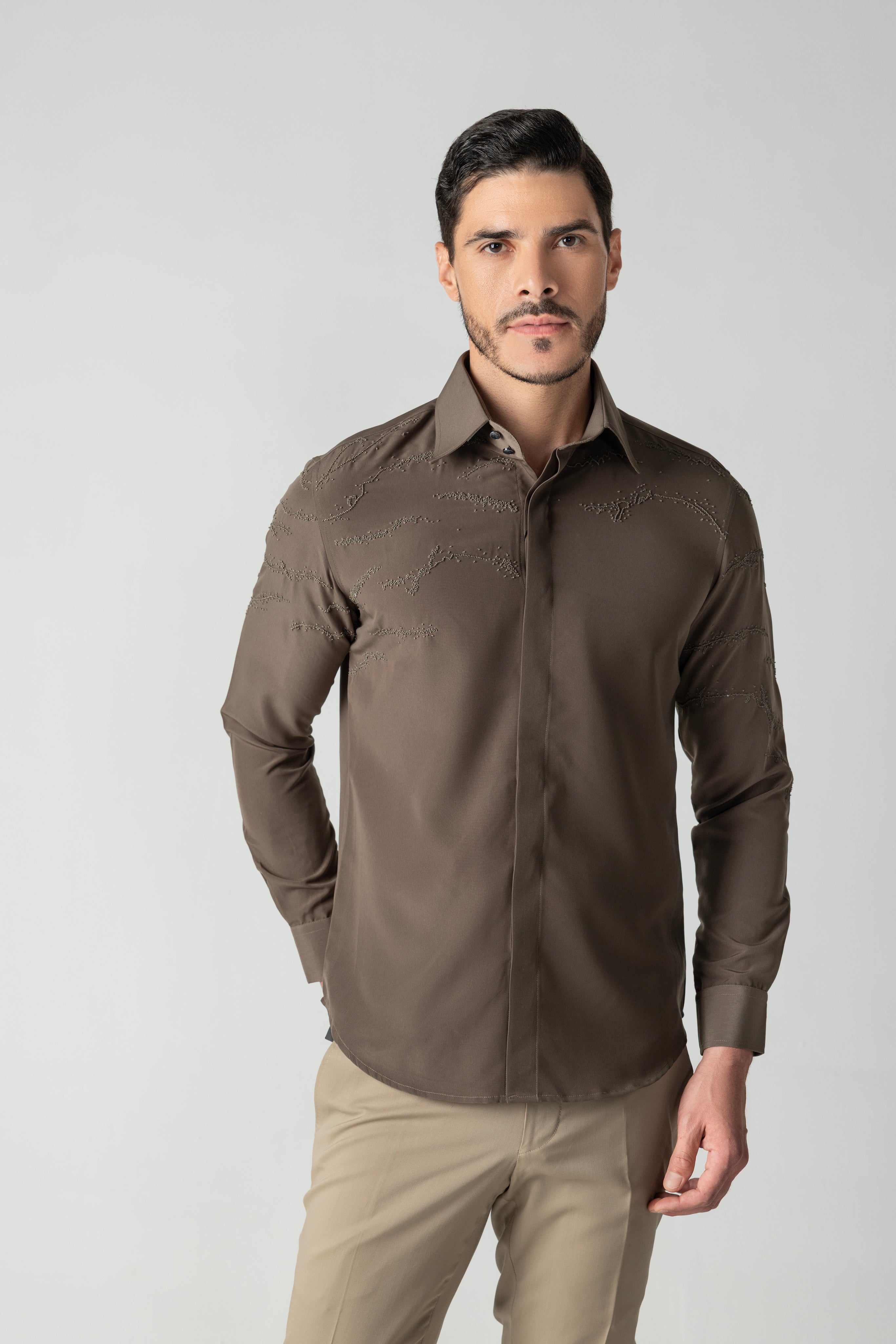 Olive green shirt with abstract monotone hand-embroidered detailing.