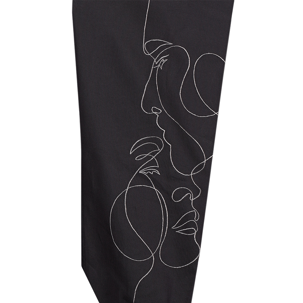 Black long-sleeved evening shirt with embroidered abstract face illustration